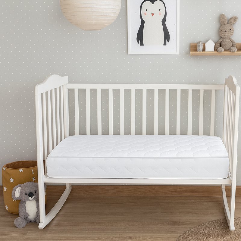 Baby crib with mattress in a nursery among things that are 52 inches long