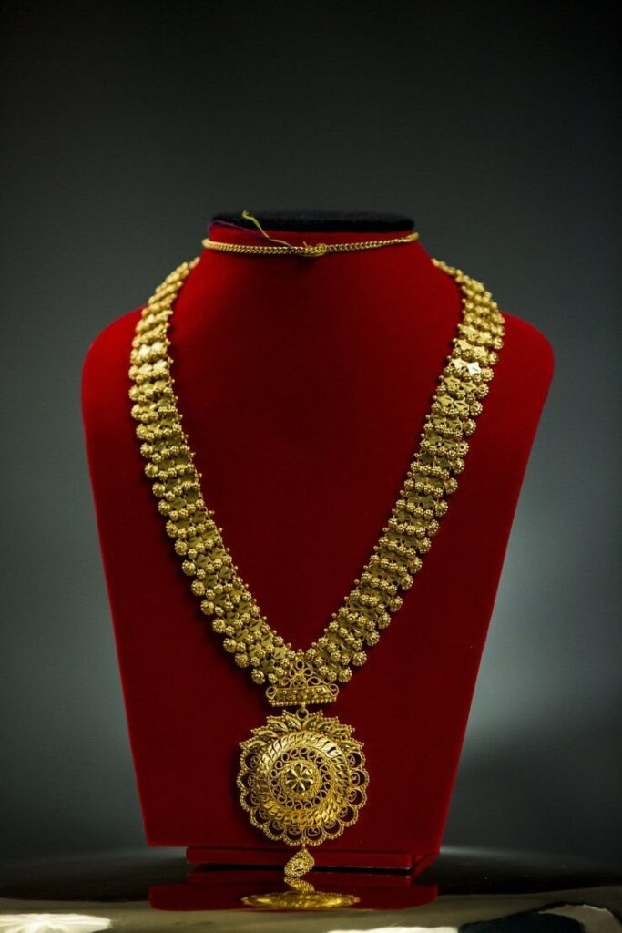 gold necklace on display, a standard 16 inch necklace length example of 16 inches