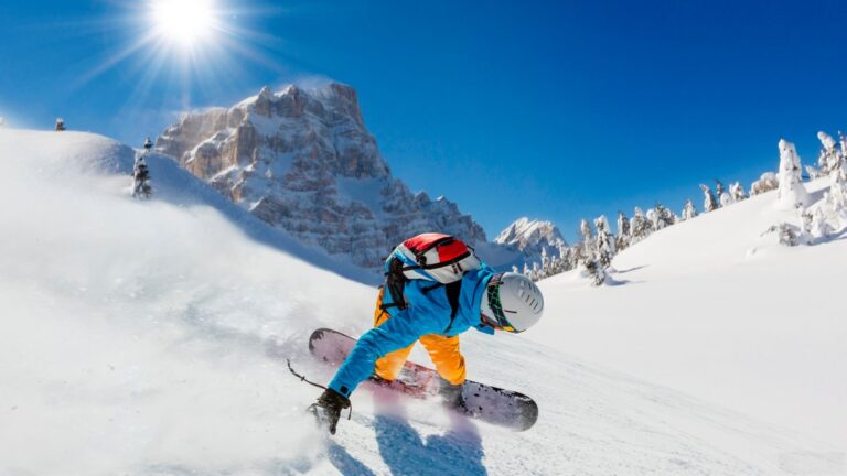 Snowboarder on a snowboard showing things that are 54 inches long