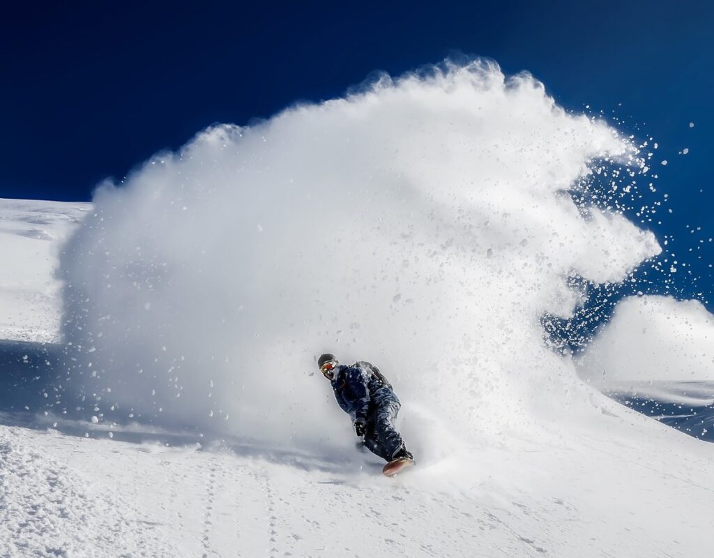 Snowboarder on a snowboard among things that are 58 inches long