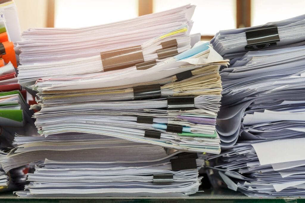 Stack of letter paper sheets on a desk illustrating things that are 44 inches long