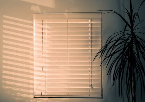 Window blinds on a window showing things that are 51 inches long