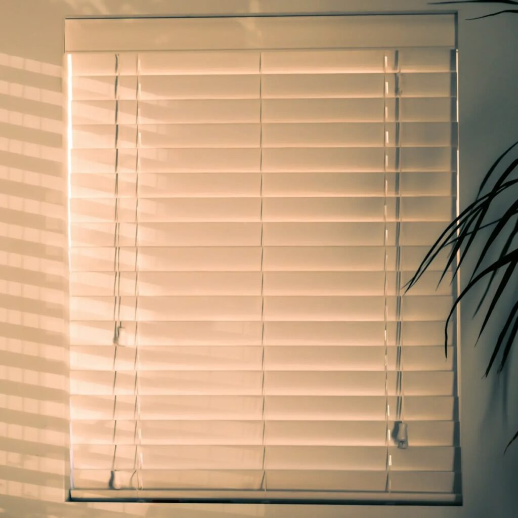 Window blinds on a window as an example of things that are 55 inches long